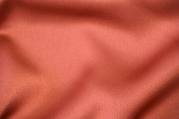 Shiny draped velour background. Wrinkled luxurious cloth background. Soft rose plush fabric with...