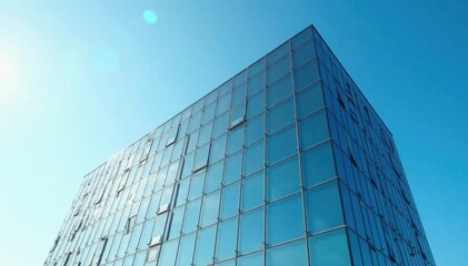 Modern glass office building against vibrant blue sky, city, facade