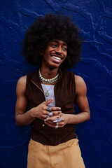 Stylish gen z man with afro hair smiling and posing