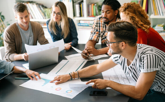 Successful multiethnic group of designers, architects, business people at work in office