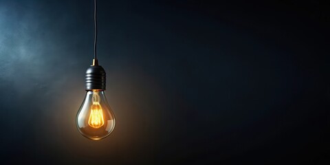 Illuminated Filament A Single Glowing Bulb Hangs Against a Dark Background, Representing Ideas and Inspiration
