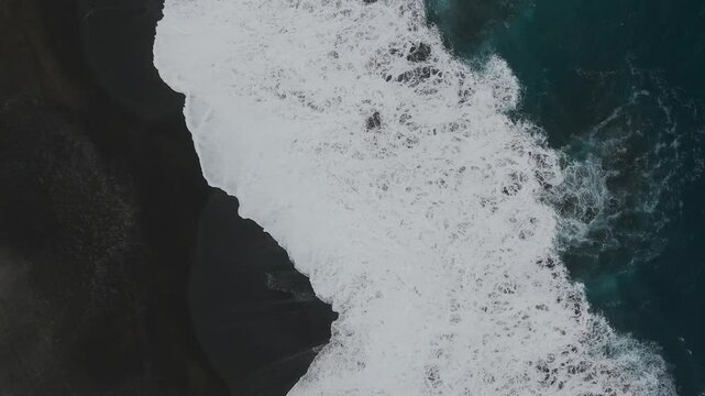 sea wave aerial view black sand drone down