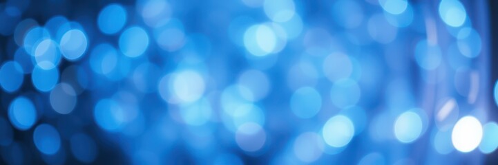 Fototapeta premium Bright blue bokeh lights create a vibrant and dreamy atmosphere in a festive setting