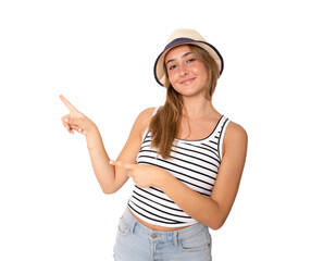 Young woman wearing straw hat pointing fingers up standing isolated over transparent background....