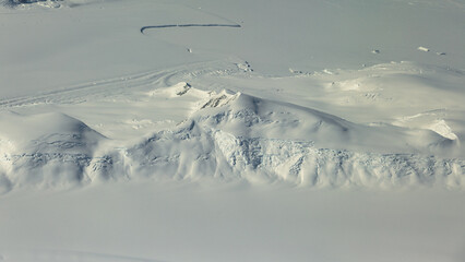 Aerial view of white mountain landscape in Antarctica.
