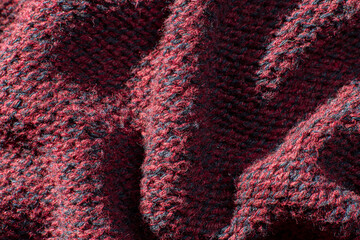 Close-up of the cotton and polyester fabric of a wrinkled red jersey