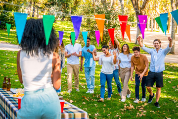 Fototapeta premium Friends arriving at a surprise birthday party in a park