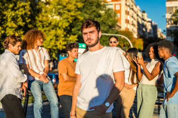 Serious casual student standing with friends at city