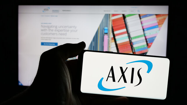 Stuttgart, Germany - 01-30-2025: Person holding mobile phone with logo of financial company AXIS Capital Holdings Limited on screen in front of web page. Focus on phone display.