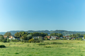 Obraz premium View of beautiful Zumberak mountains, with small, rural houses and agricultural surfaces. Croatia