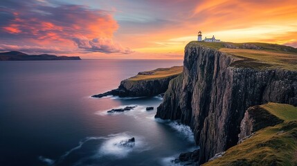 Fototapeta premium A stunning sunset over a coastal cliff with a lighthouse overlooking the ocean.