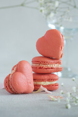 French macarons in the shape of red heart on light background, perfect for st Valentine's day and mother's day 