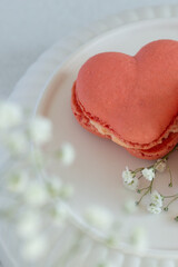 French macarons in the shape of red heart on light background, perfect for st Valentine's day and mother's day 