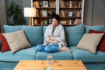 Stomach ache, cramps and hands of woman with abdomen pain due to constipation, menstruation or ibs...