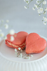 French macarons in the shape of red heart on light background, perfect for st Valentine's day and mother's day 