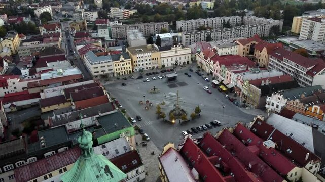 Drone video of a picturesque Czech town with red-tiled roofs and historic churches. Aerial view captures the charming architecture, narrow streets, and timeless beauty of the city.