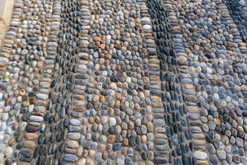 Footpath paved with pebbles and small cobblestones, fragment