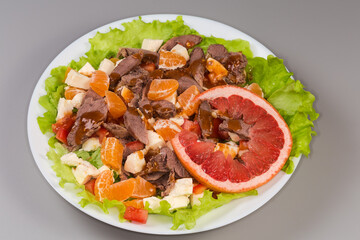 Salad with boiled duck meat, mozzarella, citrus, vegetables and greens