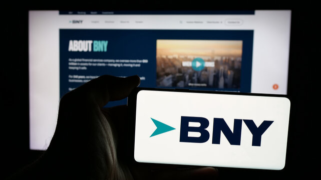 Stuttgart, Germany - 01-30-2025: Person holding mobile phone with logo of company The Bank of New York Mellon Corporation (BNY) on screen in front of webpage. Focus on phone display.
