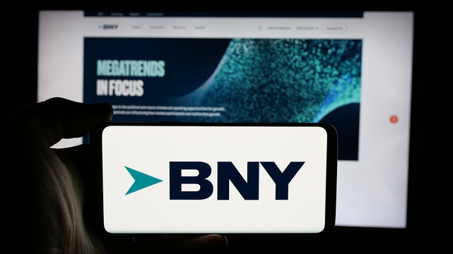 Stuttgart, Germany - 01-30-2025: Person holding cellphone with logo of company The Bank of New York Mellon Corporation (BNY) on screen in front of web page. Focus on phone display.