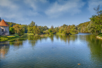 Historic Otocec castle. Slovenian national monument. Well preserved elegant fortress on a small islet on the tranquil Krka river.