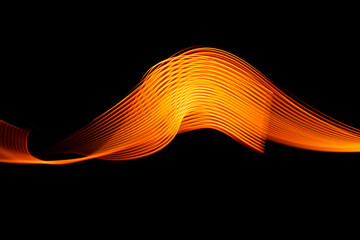 Vibrant orange light waves create a stunning abstract visual experience against a deep black...