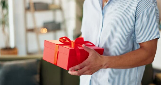 Couple love, hands and romantic with gift box for valentines day, surprise gesture and present for anniversary. Care, people and giving ribbon package for celebration, special date or support in home