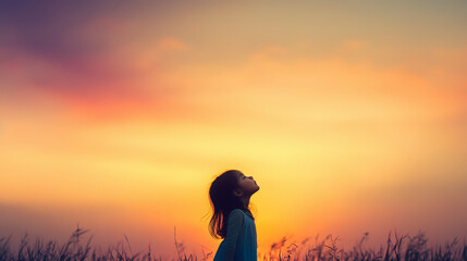 Fototapeta premium Girl enjoying a serene sunset in open field, capturing tranquility and nature's beauty. Perfect for relaxation and mindfulness.