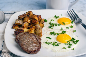 two  fried eggstop with parsleyserved with  sausage pattioes