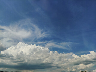 Expansive blue sky with dramatic clouds forming over Czechia, capturing the beauty of a summer day in july