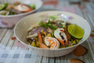 A bowl of special food of dry egg yellow noodle with crawfish, shrimp and crab, sold in Chanthaburi province, Thailand