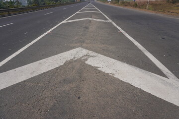 These road markings are designed to guide drivers and regulate traffic flow