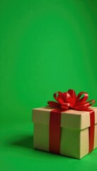 Green background with a red bow and a gift box in the foreground, holiday packaging, presents, Christmas gift boxes