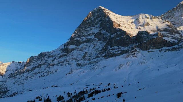 Eiger North Face Mountain at Sunset in Winter. Swiss Alps. Switzerland. Aerial View. Moving Forward