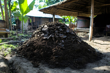 Heap of natural compost material in a rural farmyard setting