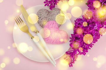 Gentle spring table setting with handmade hearts and lilac flowers.Valentine's or Mothers Day