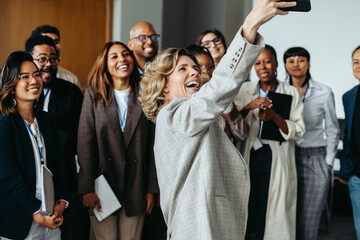 Team gathering for a joyful photo as coworkers capture a memorable moment together during a break...