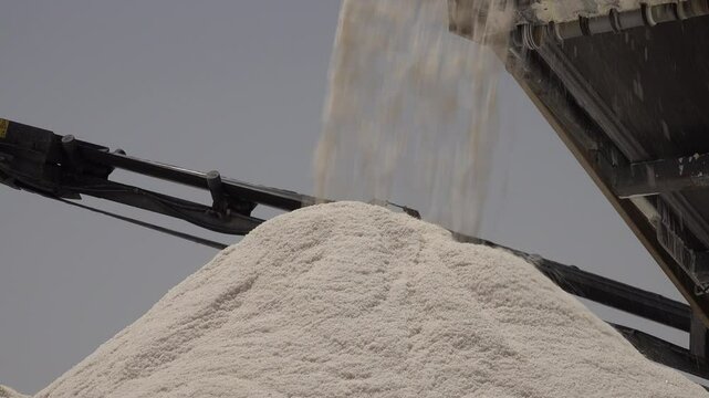 Close-up of salt dropping on huge pile in production facility in Chott el Djerid, the largest salt pan in the Sahara desert in Tunisia
