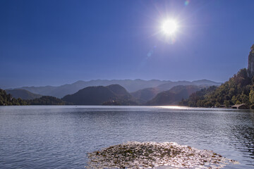 The Bled lake with forested mountains in the background in Slovenia.