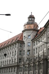 Historic European architecture blending seamlessly with modern buildings. A captivating contrast of old-world charm and contemporary design, showcasing the rich cultural layers of city life.

