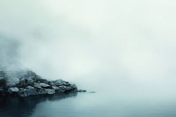 Serene Misty Lake with Rocks and Ethereal Foggy Background