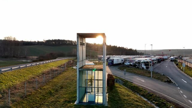 A mesmerizing aerial video of a small chapel beautifully illuminated by the golden sunset. The warm sunlight enhances the architectural details, creating a breathtaking contrast between the sacred str