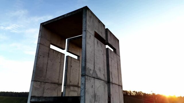 A mesmerizing aerial video of a small chapel beautifully illuminated by the golden sunset. The warm sunlight enhances the architectural details, creating a breathtaking contrast between the sacred str