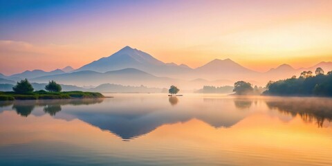Naklejka premium Serene Sunrise Over Misty Mountain Lake with Island Tree Reflection