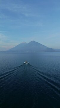 Boat crossing Atitlan lake facing Atitlan and Toliman volcanos