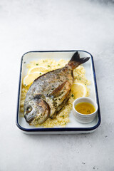 Baked dorado with lemon and couscous