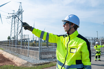 Engineer with radio at wind turbine site