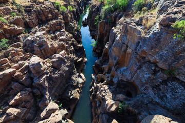Blyde River Canyon deep gorge surrounded by rocky cliffs and lush vegetation in South Africa