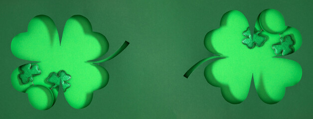Top view of a frame in shape of clover leaves with themed decorations for  holiday of St. Patrick's...