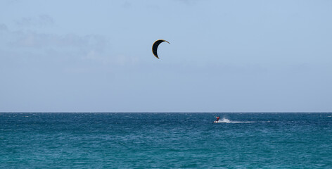 Kiteboarding Adventure with Diverse Participants on Sunny Ocean Waves